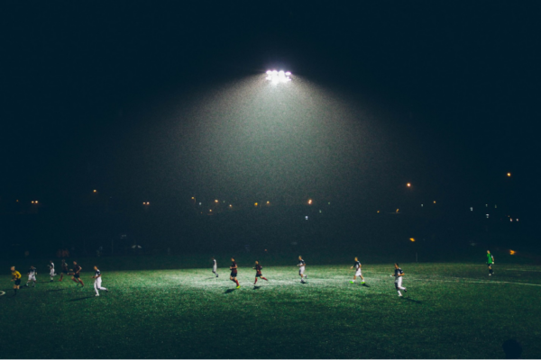 Amateur footballers play at night